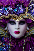 Close-up portrait of a gorgeous Carnival model in a bright purple costume.