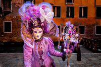 Mysterious customed Carnival model dressed in lavender.