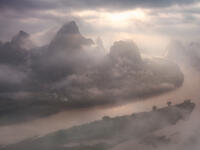 The sun breaking through virtually complete cloud cover to light up an iconic scene.