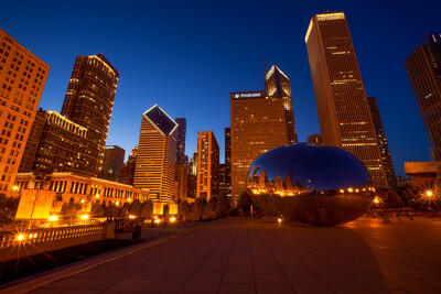 The Chicago skyline and the Bean during twilight.