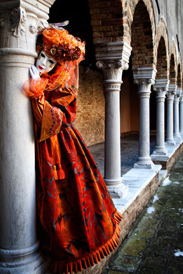Beautifully dressed Carnival model in a pillared courtyard.