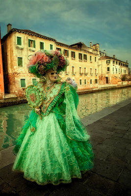 Green costumed Carnival model on Burano Island in Venice.