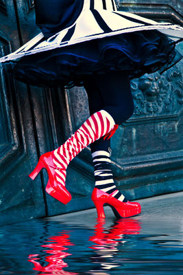 Outlandish bright red shoes and striped socks at Carnival in Venice.