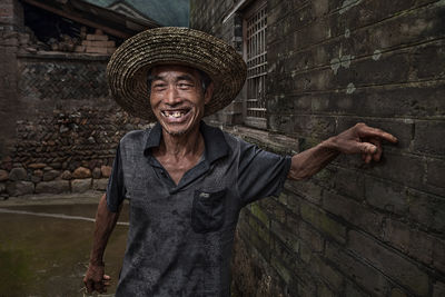 Portrait of a friendly Chinese villager stopping to talk along his way.