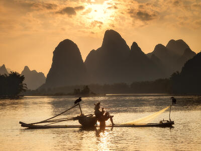 A fisherman on the Li River taking a break at sunset.