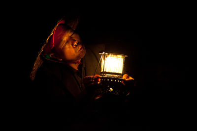Close-up of a Chinese fisherman firing up his lantern early in the morning.