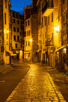 A blue and gold twilight scene in a small Italian town.