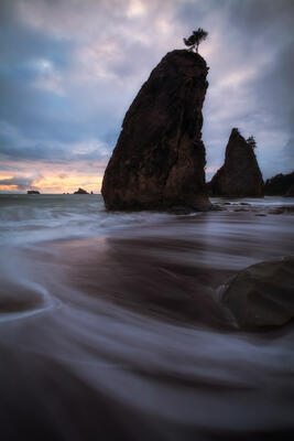 Retreating water creates foreground visual interest in front of iconic sea stacks on Washington's coastline.