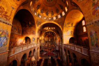 The beautiful gold interior of an ornate basilica.