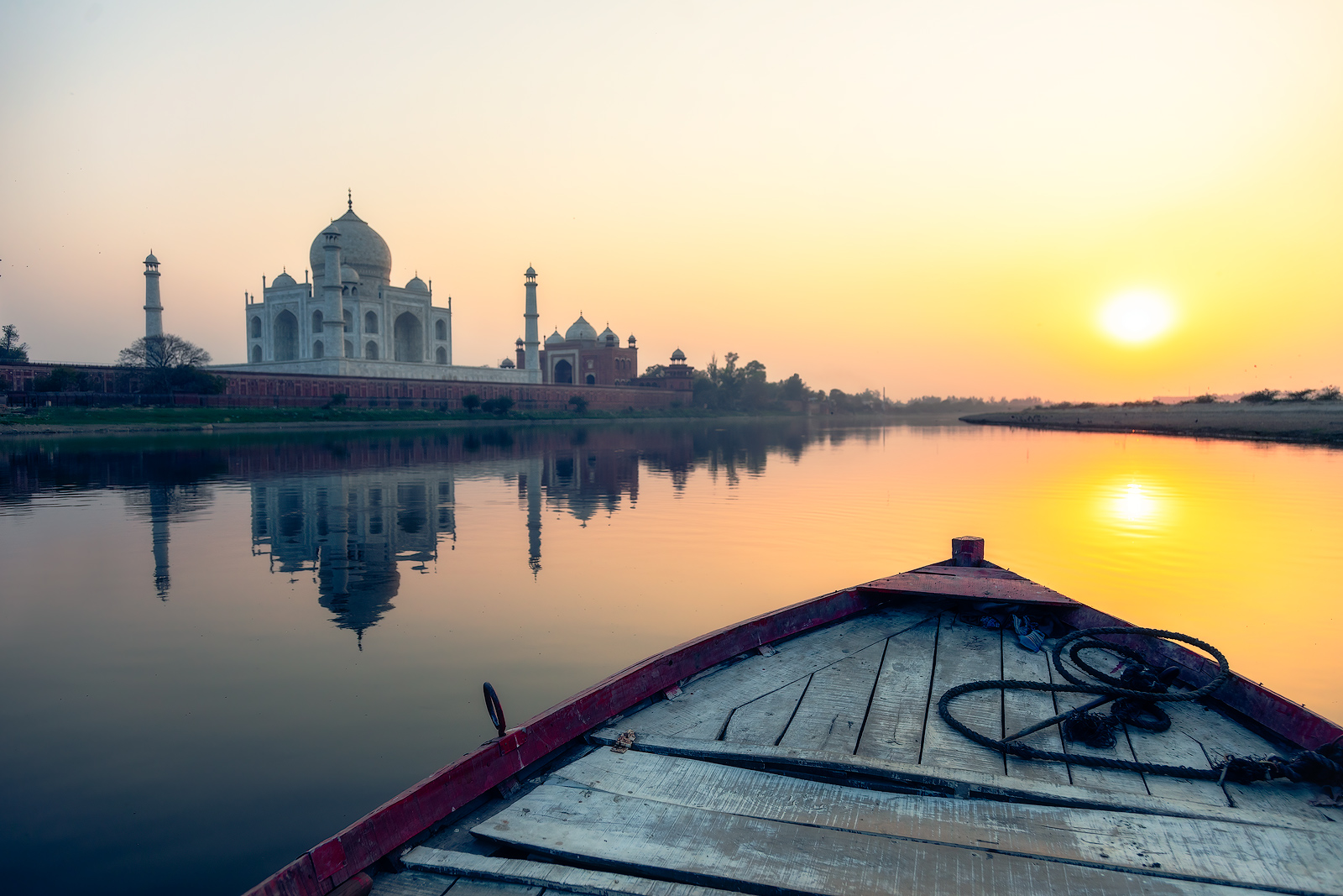 Aboard a fishing boat behind the amazing Taj Mahal at sunset.