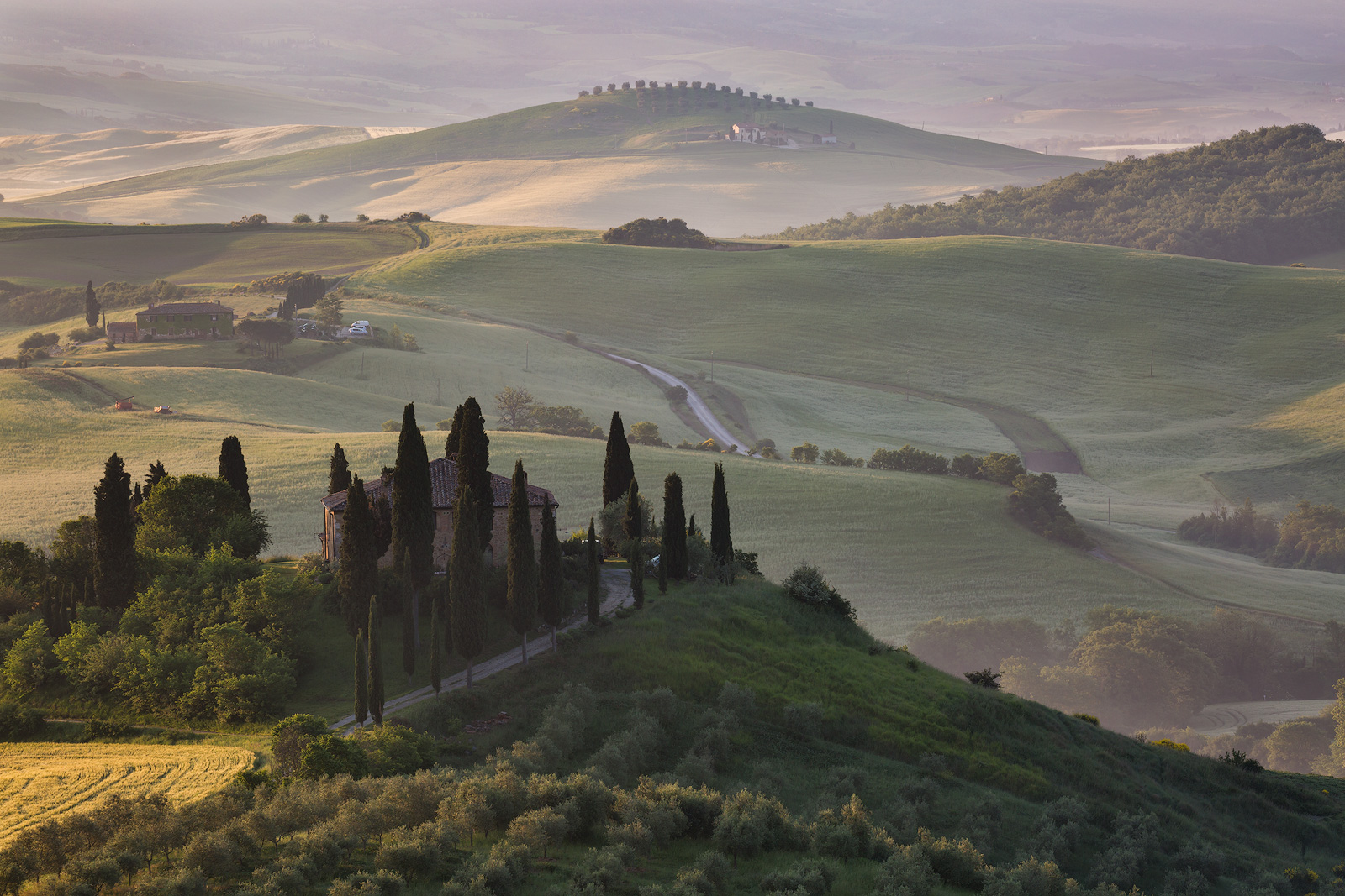 Sun breaking through to side-light the hills of Tuscany.