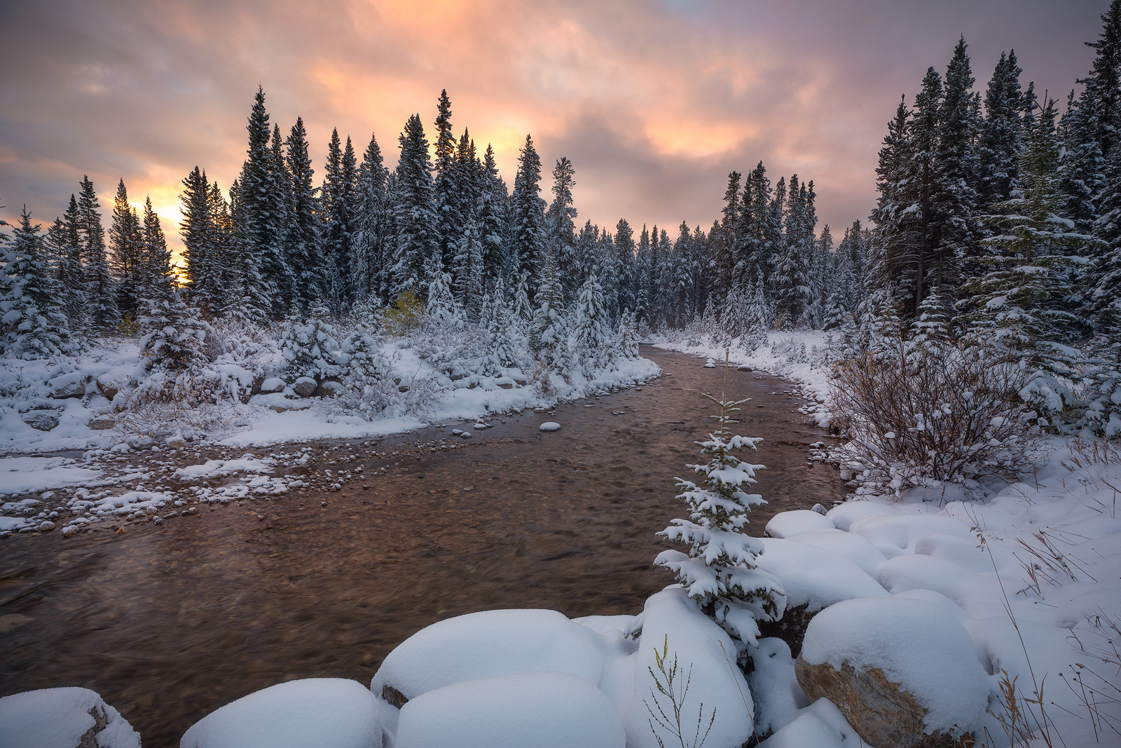A creek cuts through a Winter wonderland in the Canadian Rockies.
