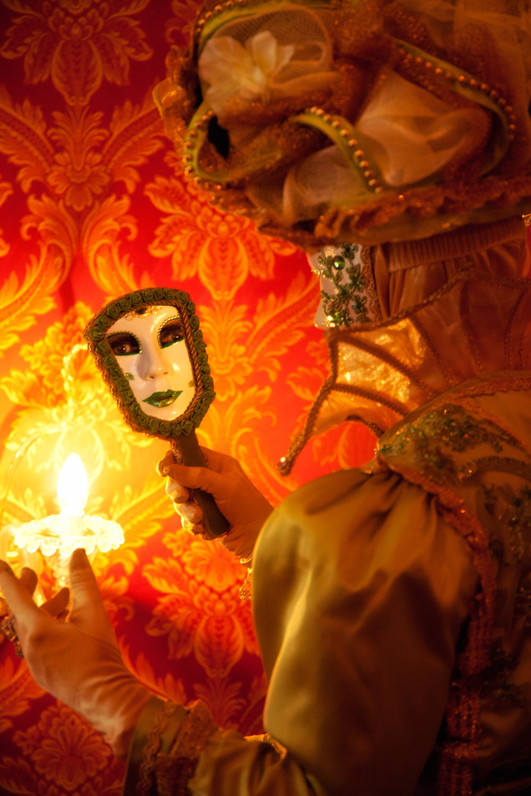 A Carnival model in green looking in a mirror