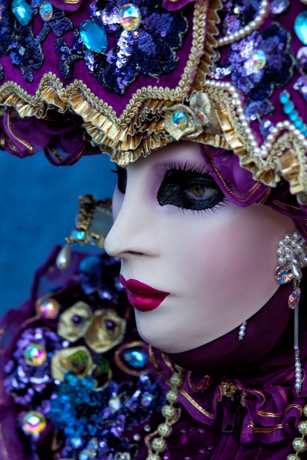 Profile of an beautifully ornate Carnival masked model.