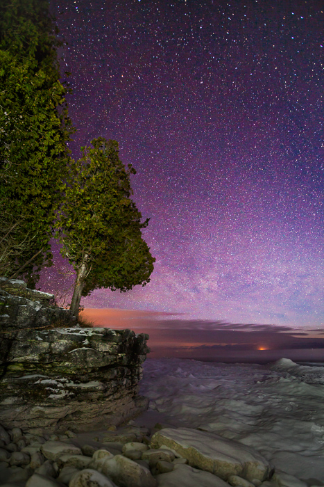 Stars in the night sky over Door County's Cave Point in Winter