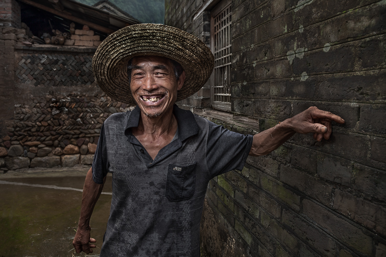 Portrait of a friendly Chinese villager stopping to talk along his way.