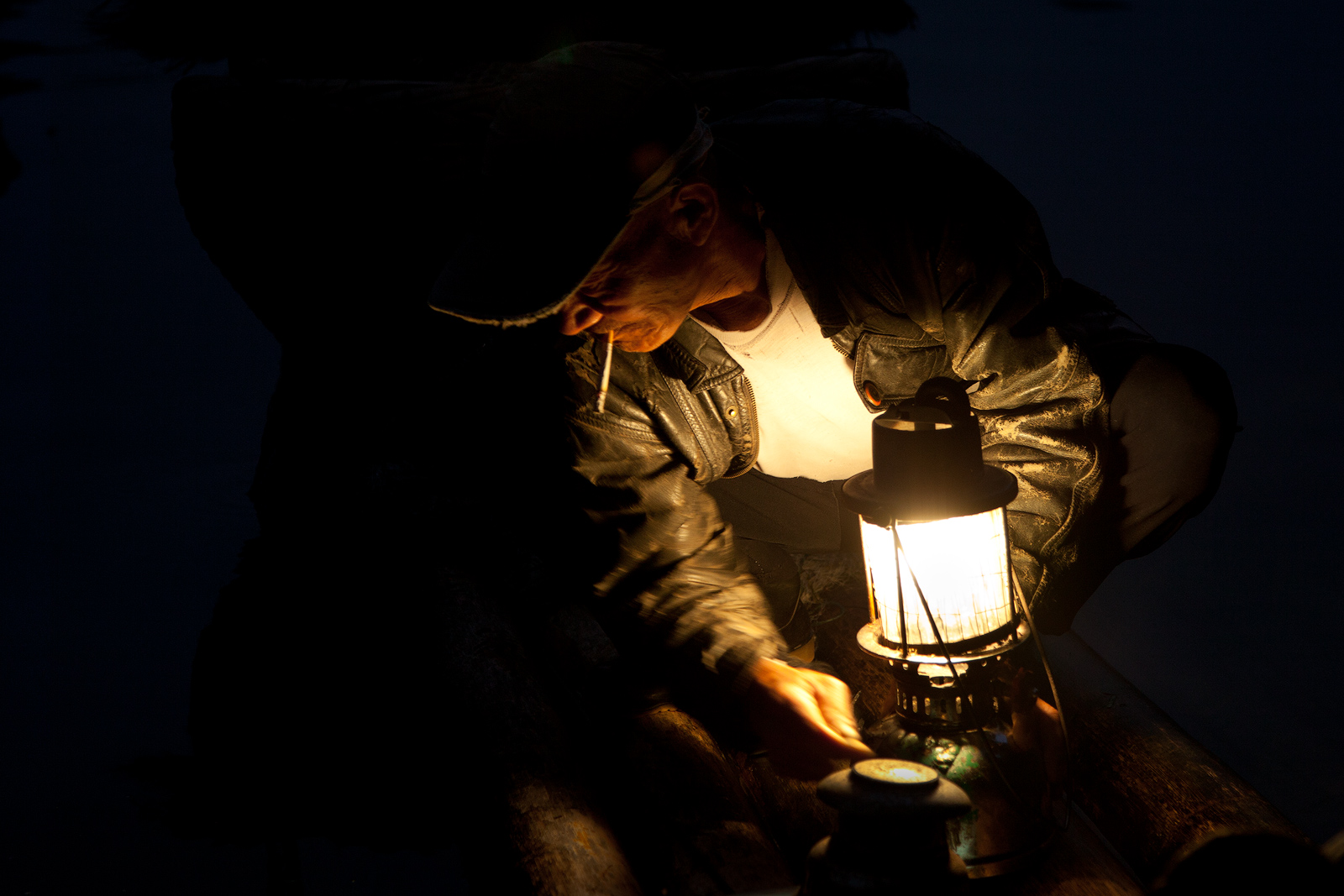 Portrait of Chinese fisherman lit by a lamp