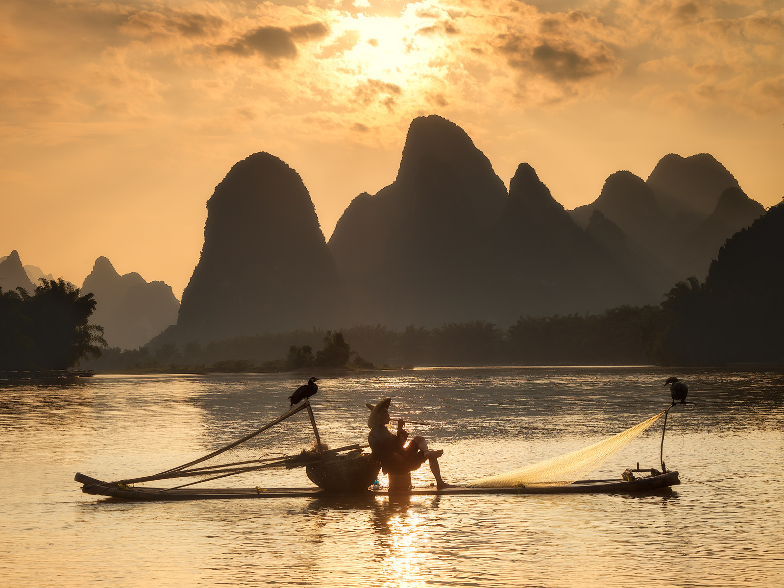 A fisherman on the Li River taking a break at sunset.