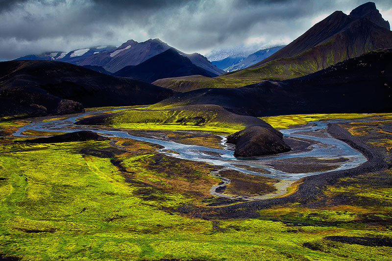 Looking down over the plains with volcanoes in the background