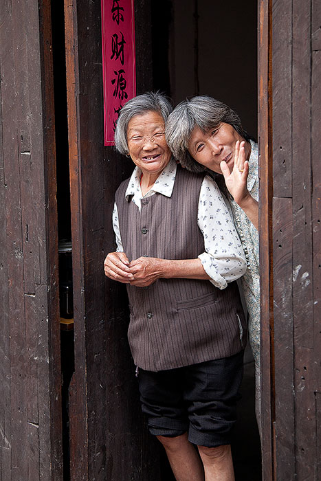 Two friendly Chinese women in a doorway