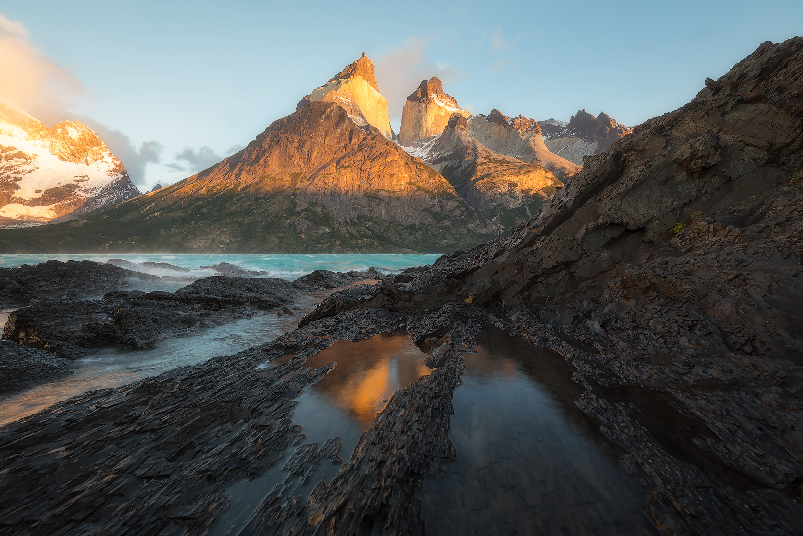 Extreme winds send waves crashing over the shoreline at the foot of Los Cuernos.