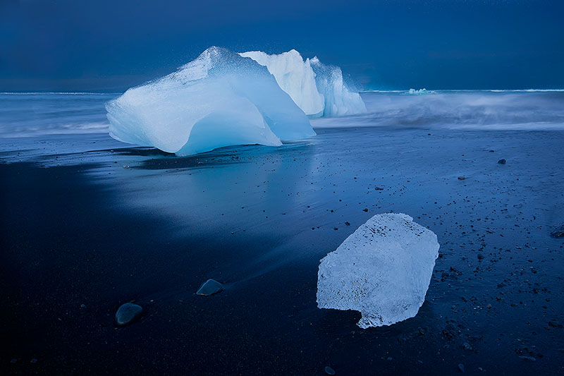 Icebergs washed up on a black sand beach
