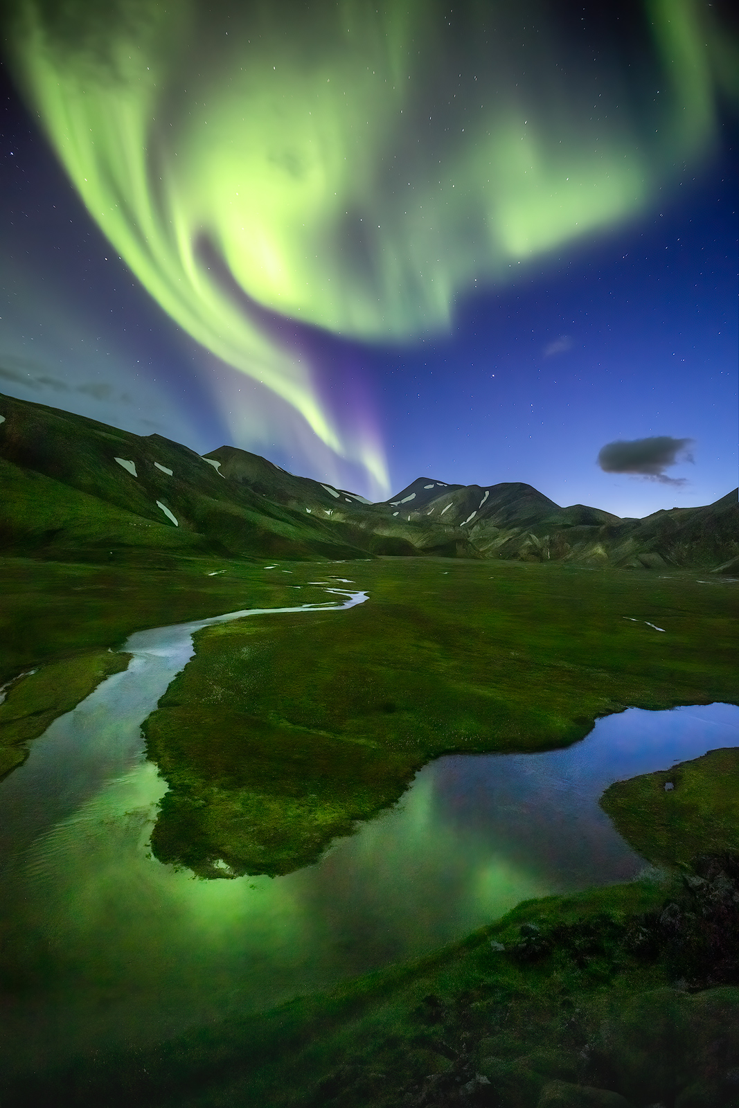 Amazing Northern Lights dancing over a beautiful meadow in Landmannalaugar, just shortly before the road closed for the Winter...