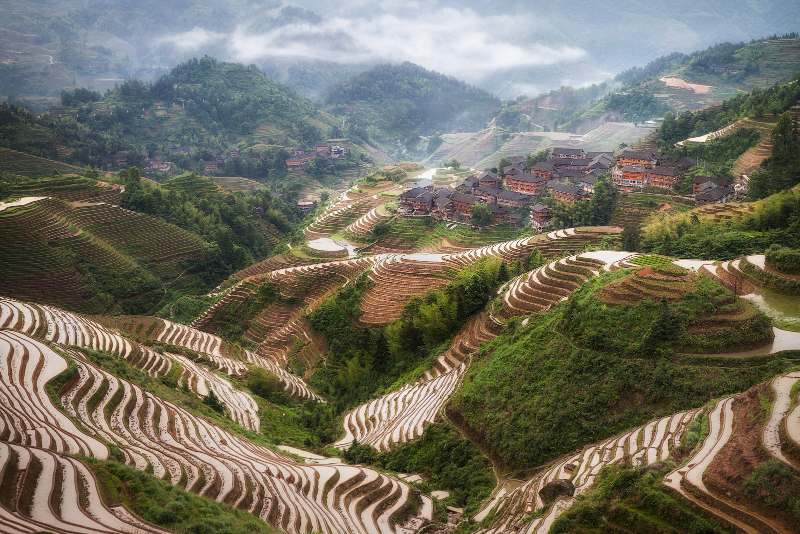 Clouds moving in over the Longji Rice Terraces shortly after sunrise.