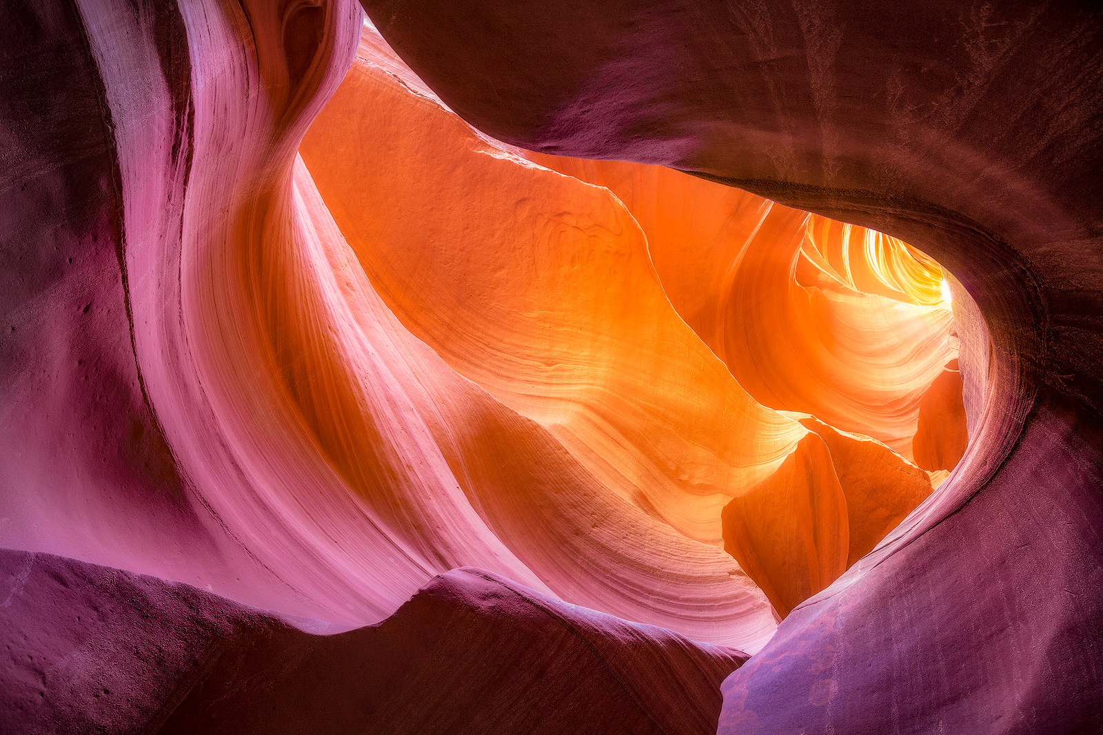 Light pouring into a slot canyon creating beautiful color variety.