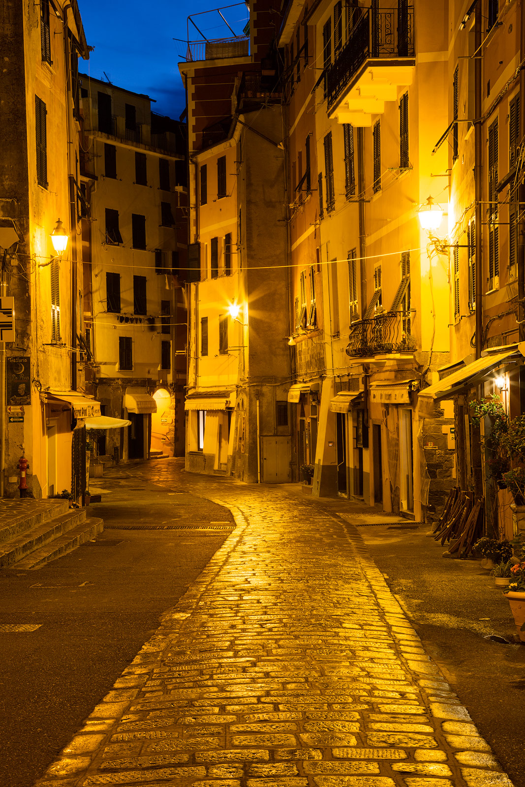 A blue and gold twilight scene in a small Italian town.