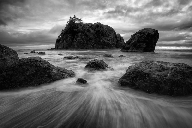 Water retreating between rocks on the shores of Ruby Beach