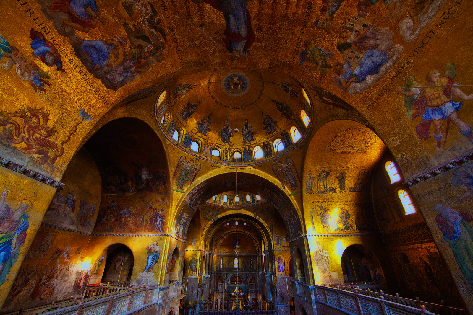 The interior of an ornate golden basilica.