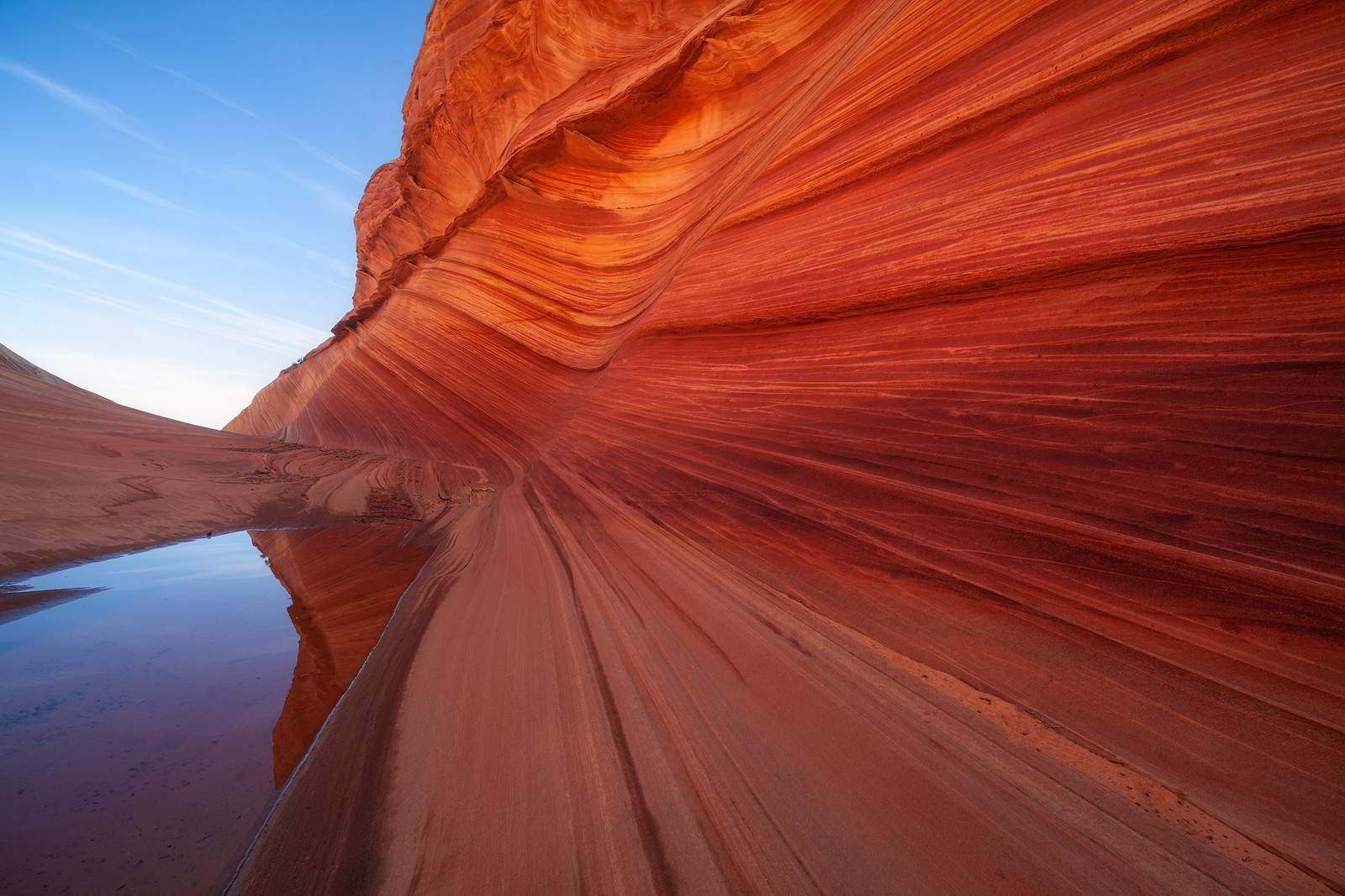 Reflection of the bright orange sandstone of the Wave