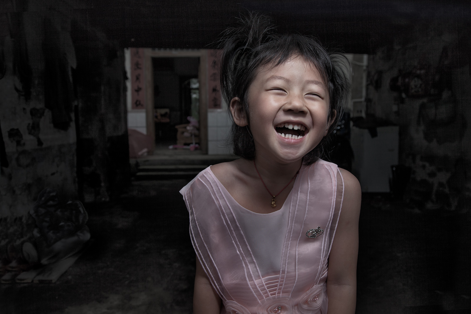 A young Chinese girl is thrilled to get her picture taken.